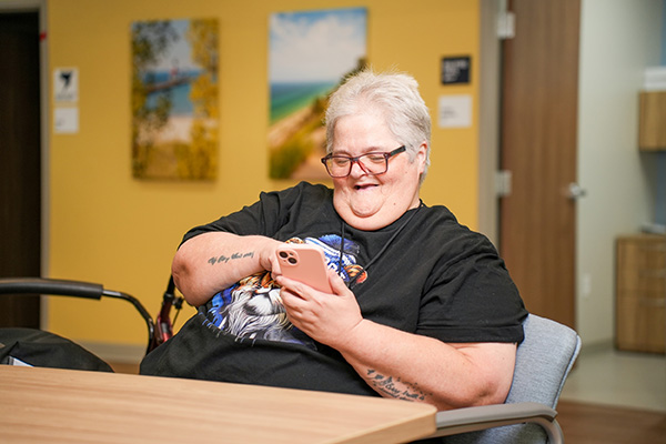 Care Resources PACE participant on their phone.
