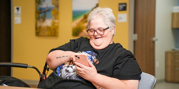 Care Resources PACE participant on their phone.