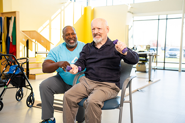 Care Resources team member with participant in the rec center.