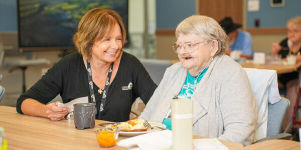 Care Resources team member sitting with a participant.