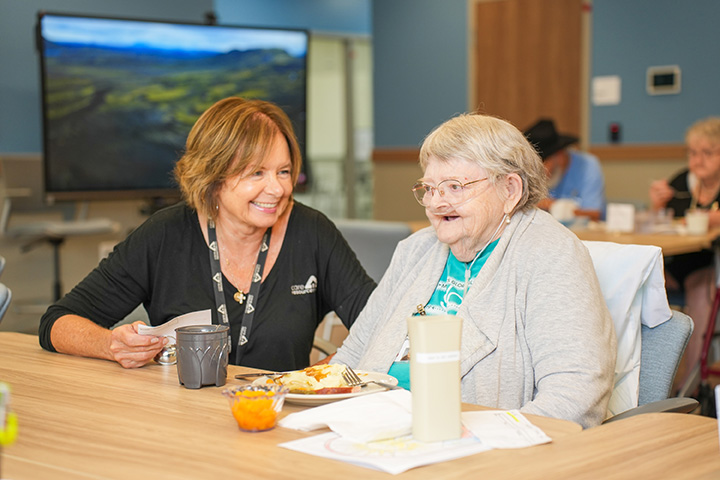 Care Resources team member sitting with a participant